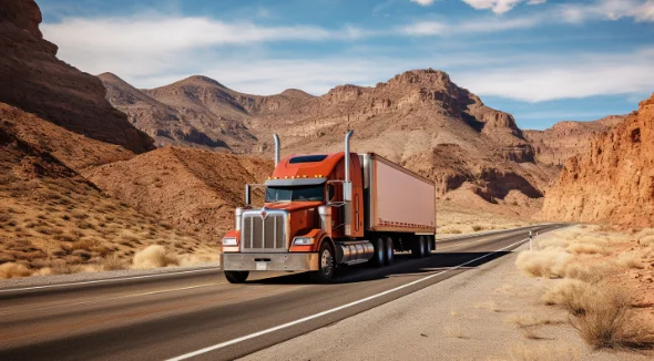 A red truck driving through the desert