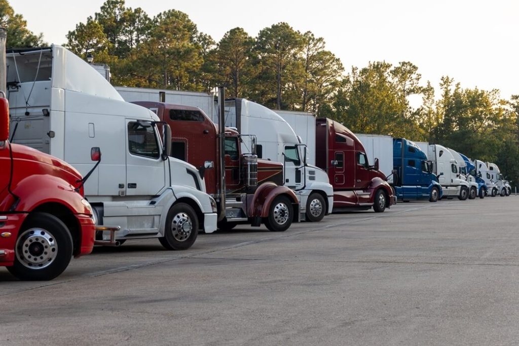 semi trucks parked in at a truck parking facility
