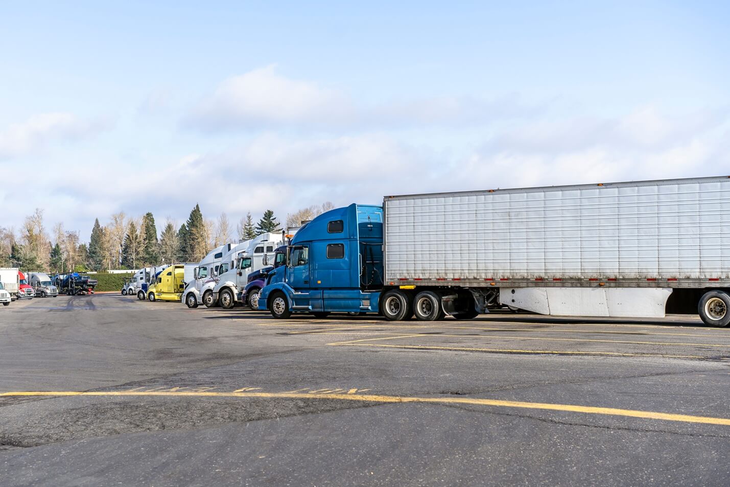 big rig semi trucks parked in a private lot