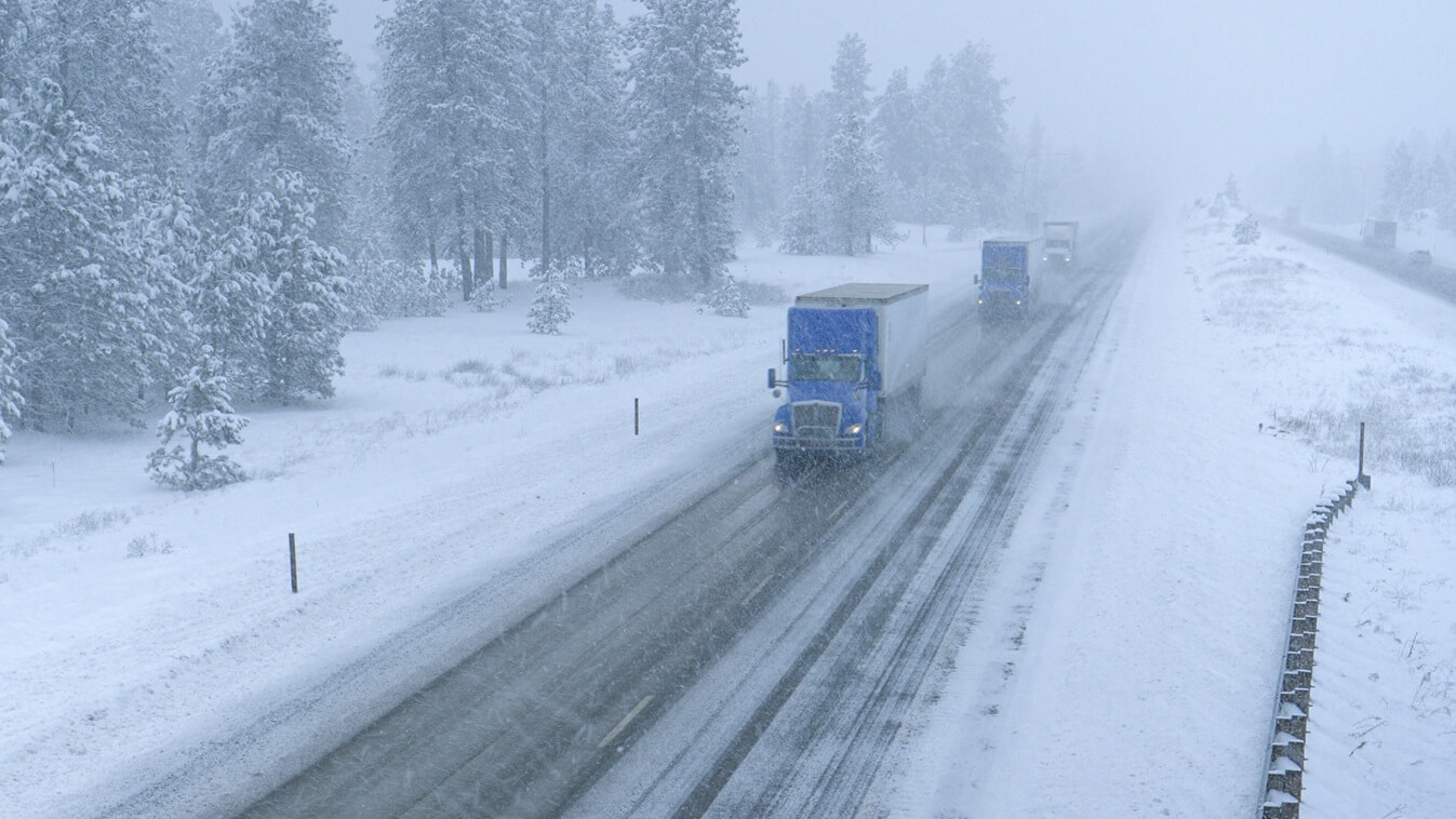 trucks hauling containers across the state of Washington and through a snowstorm