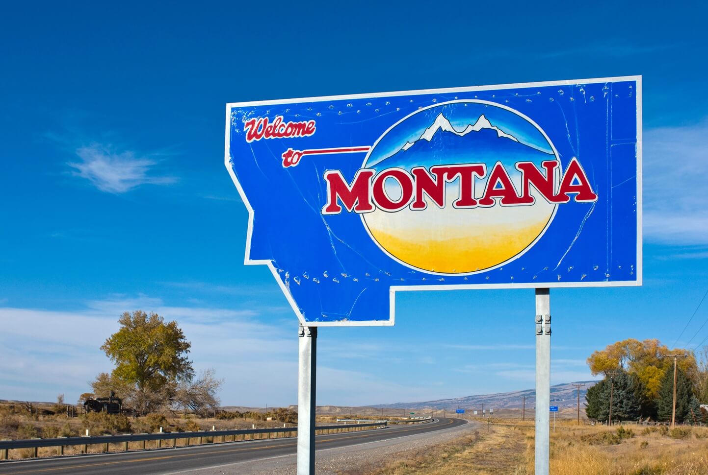 welcome to montana sign next to a highway