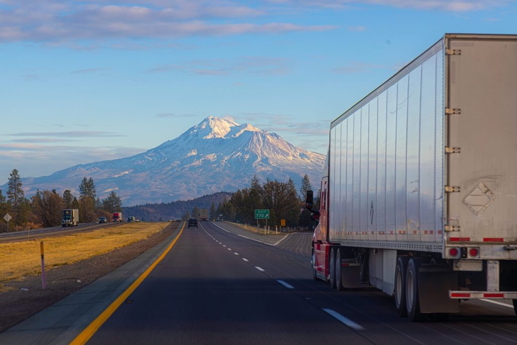 semi tractor trailer truck drives on the Interstate in california