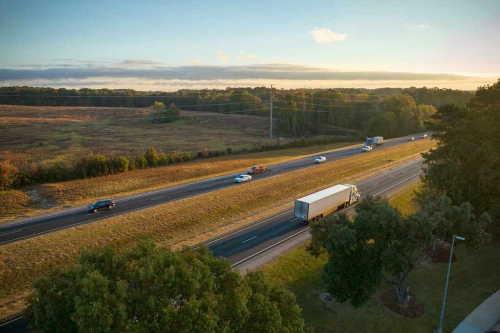 view from above of busy american highway with fast moving trucks and cars