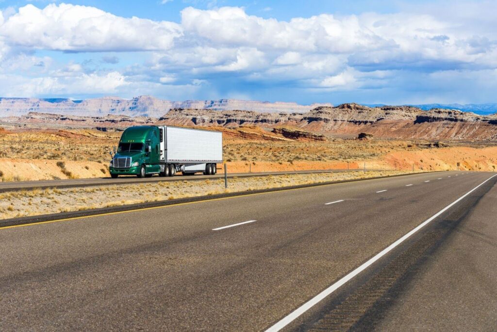 semi-trailer truck driving on interstate highway I-70 in desert land, utah