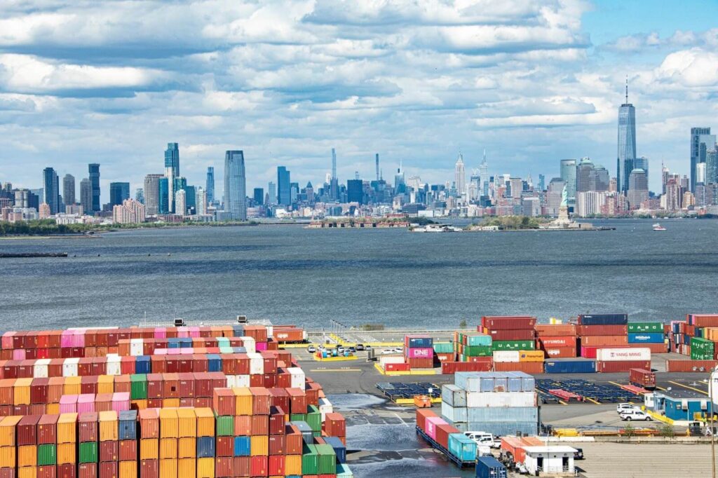 a shipping yard with New York in the background