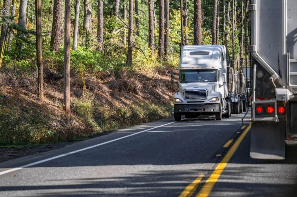 white semi rig driving on the road